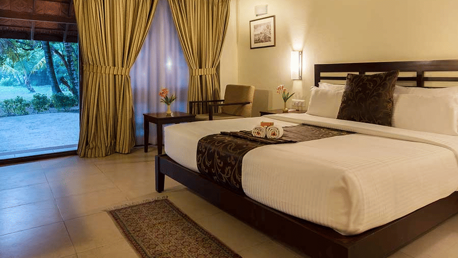 A well-furnished hotel room in Abad Turtle Resort, Marari Alleppey, an Alappuzha beach resort featuring a neatly made double bed