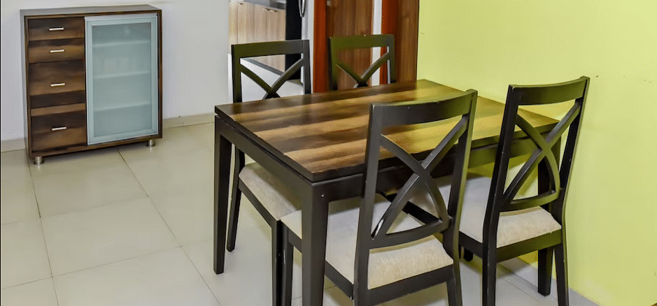 Side view of the dining area with a table and chairs at La Vida Studio Inn Goa.