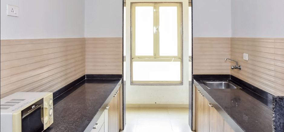 Kitchen area with countertops and a window at La Vida Studio Inn Goa.