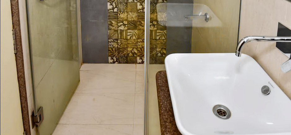 Bathroom area with a sink and shower at La Vida Studio Inn Goa.