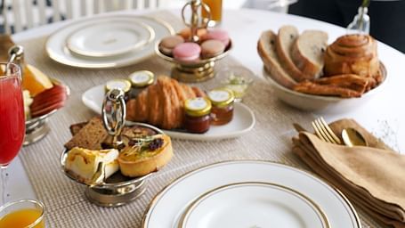 A breakfast table arrangement in the outdoor patio area of Dileep Kothi, Jaipur