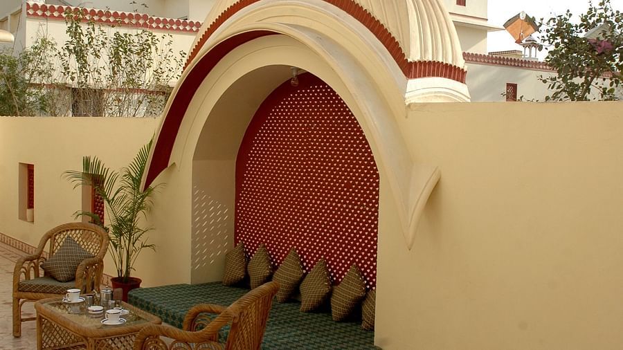 Seating arrangements on the side with a chair and a small table - Mandawa Haveli Jaipur