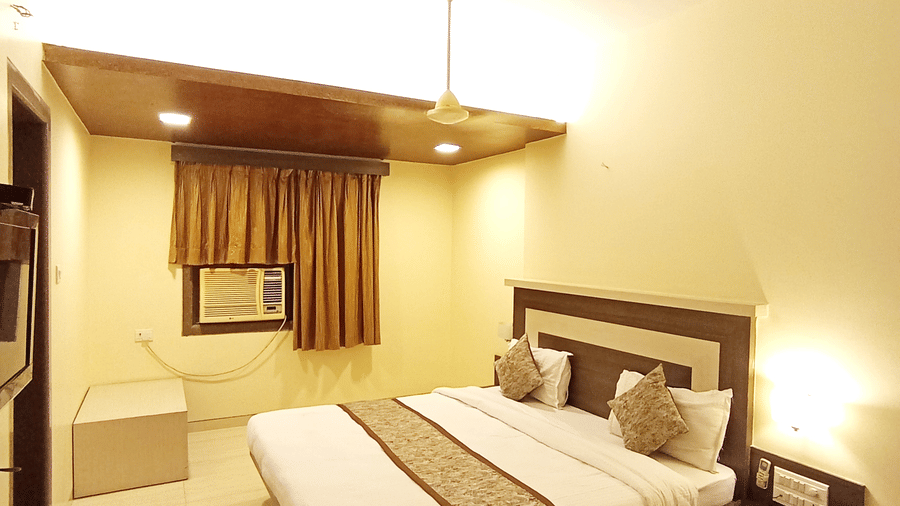 Vertical view of Executive room featuring a neatly made bed and soft ambient lighting.