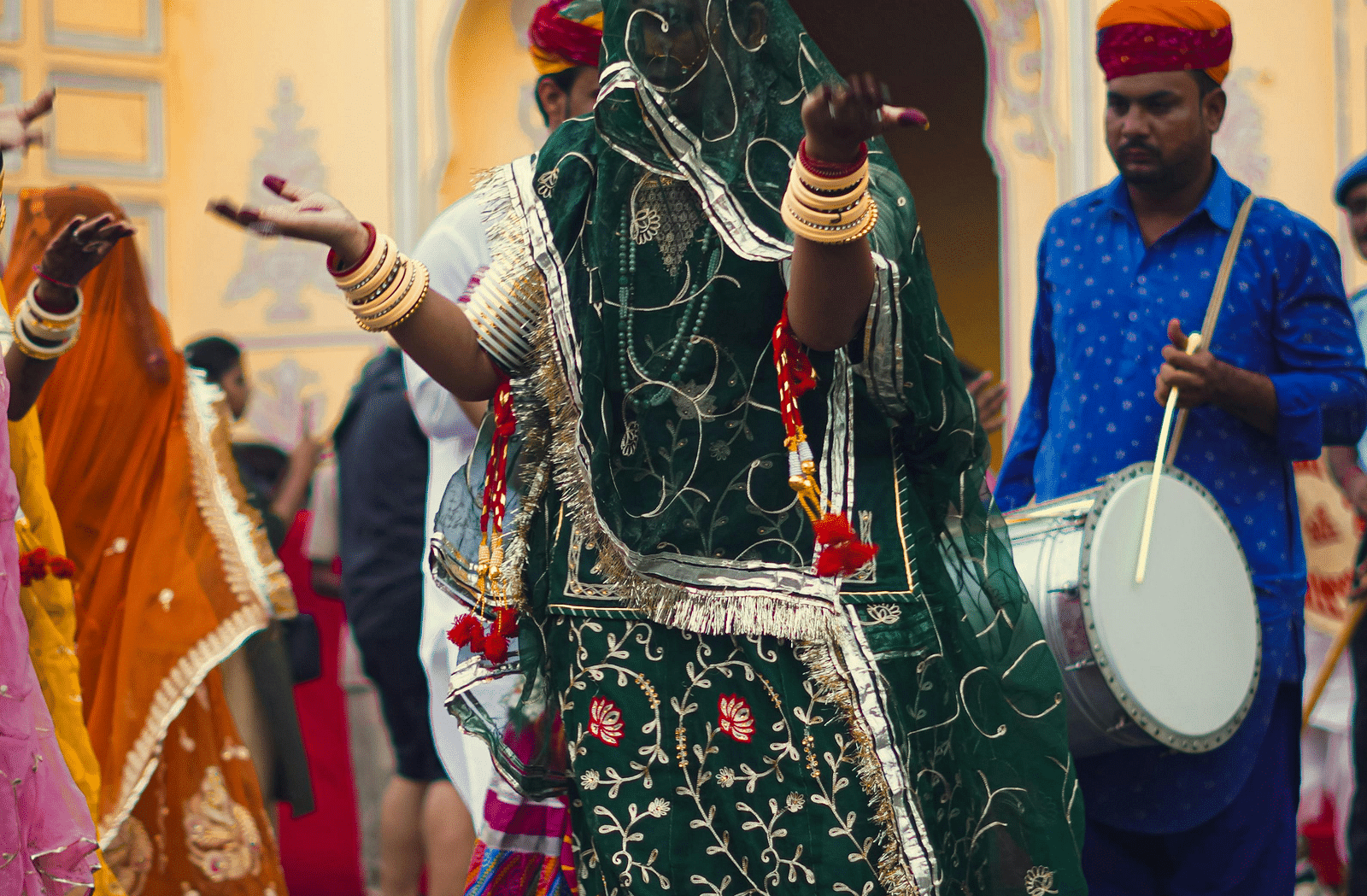 image of a woman dancing with a green veil covering her face drawn over her head