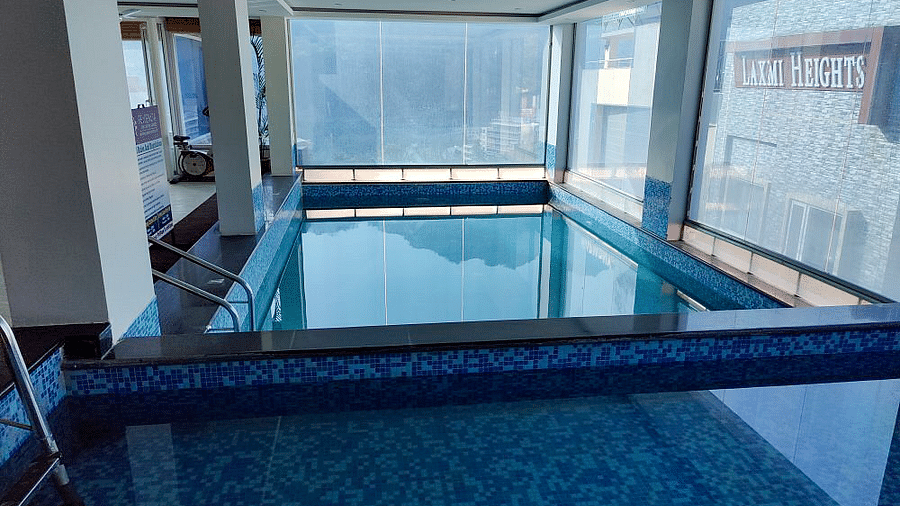 Full view shot of the swimming pool divided by a small partition in the middle at Regenta Inn DLS.