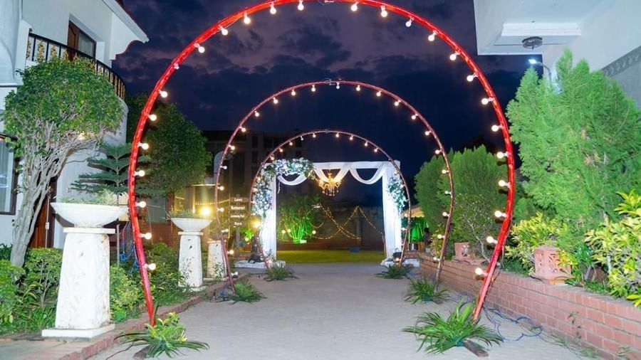 Romantic entrance walkway with red circular arches lit with string lights at Ilara Hotels & Spa, OMR, Chennai