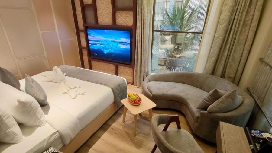 Suit Rooms with a comfy bed and a flat screen TV, a comfortable sofa , table and chair at Maxxvalue Hotel, MIDC