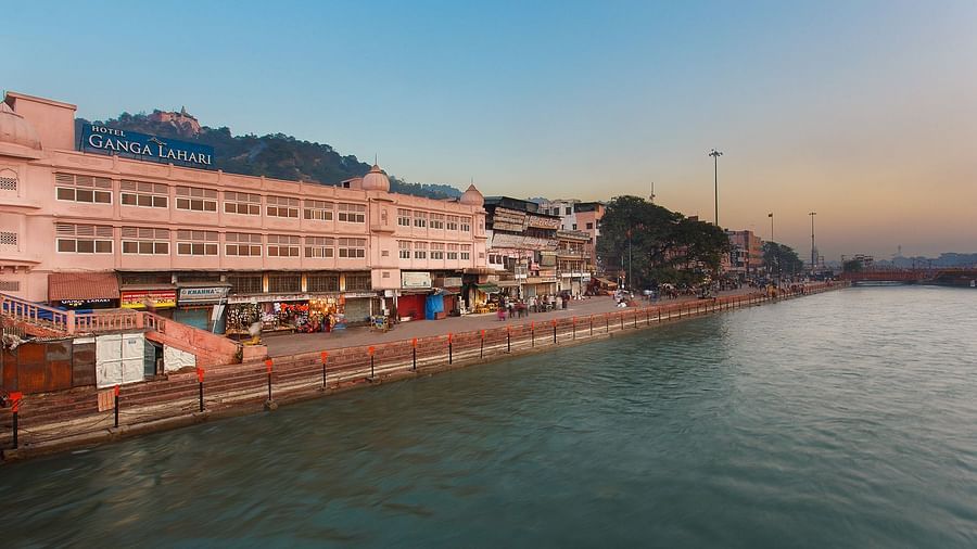 The Ganges River flowing through Haridwar, India, with people bathing and performing rituals.