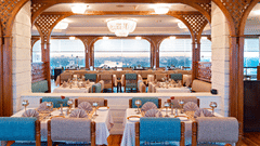 A vibrant, stylish Fine-Dine Restaurant in Lucknow with a modern, lattice-style ceiling and large windows overlooking a scenic view at Clarks Avadh, Lucknow - One of the Best Restaurants in Lucknow.