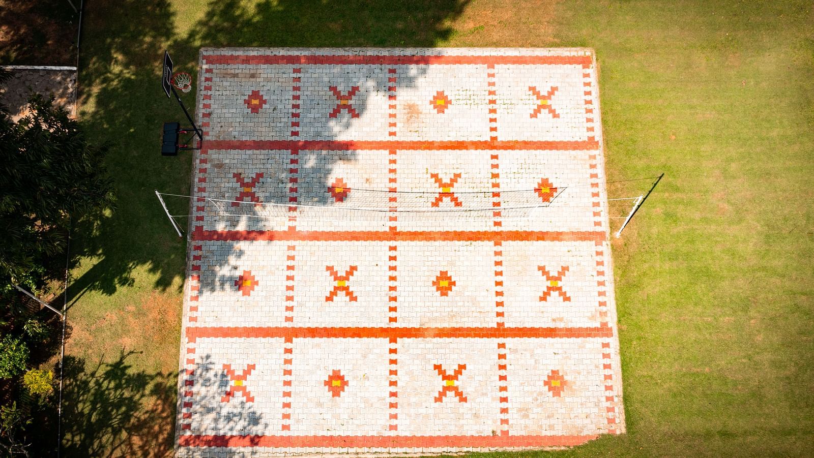 An image of an outdoor game in the lawn surrounded by greenery - GReaT Trails River View Resort Thanjavur By GRT Hotels