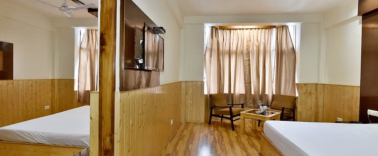 A room at DLS Hotel Devlok, Manali with a double bed and wooden flooring