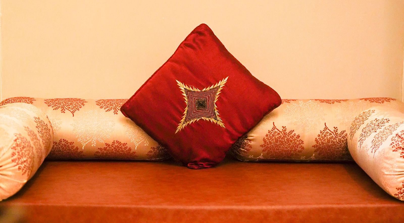 An image of a couch with cushions around the sitting space