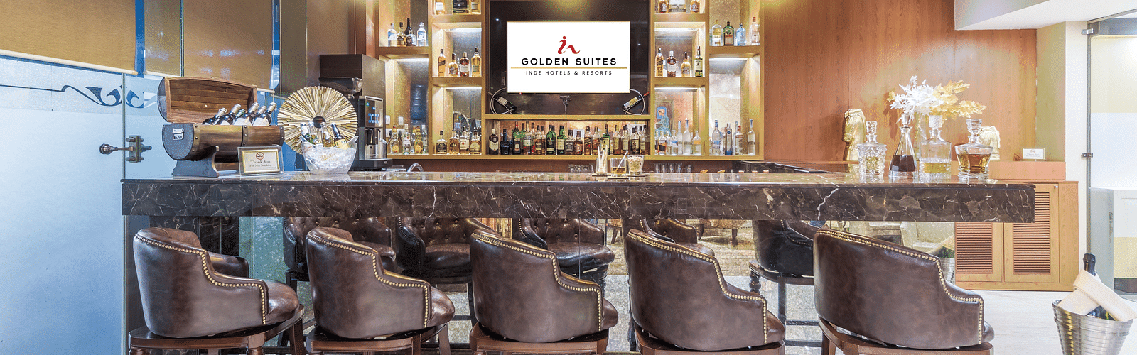 A front view of bar with aligned chair at Golden Suite