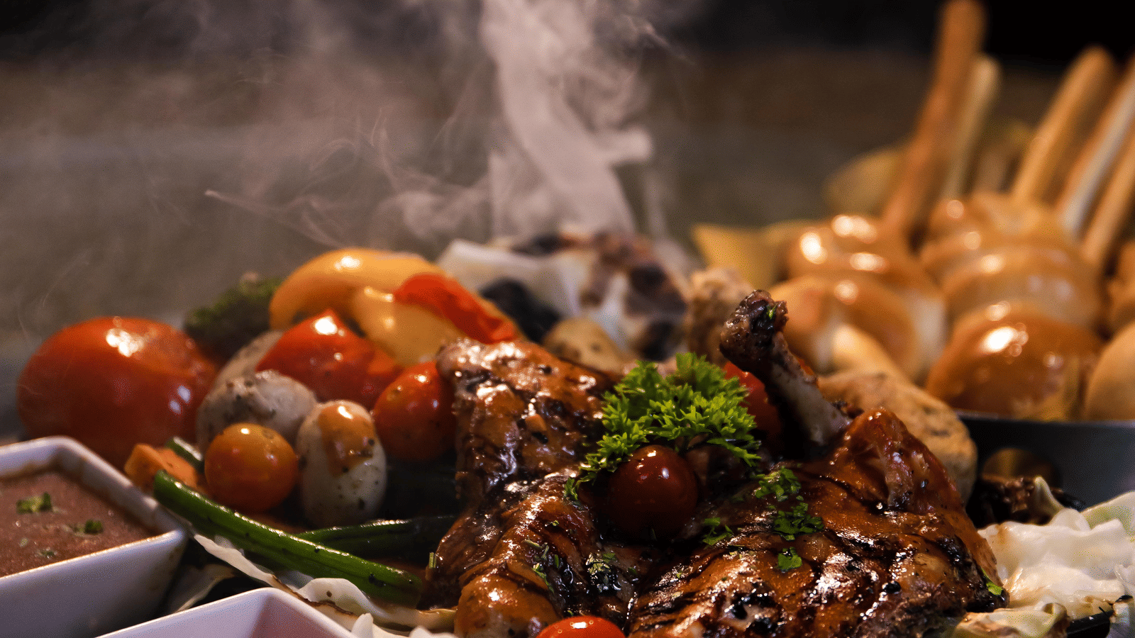 Barbequed chicken served alongside some vegetables
