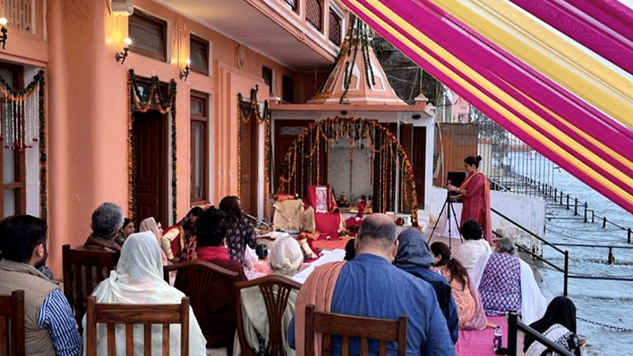An event space with several people performing rituals. | Hotel Devnadi, Haridwar