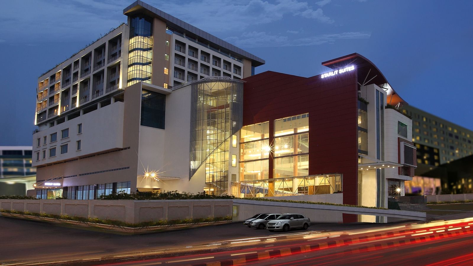 Facade image of Starlit Suites, Kochi in the evening with the lights on