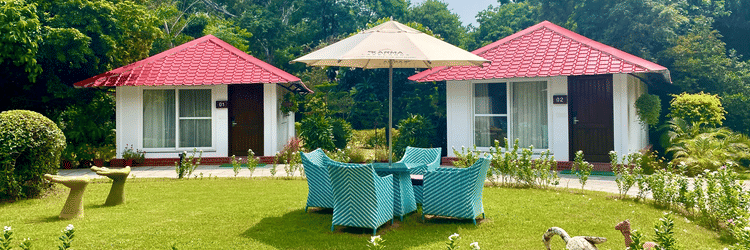 Facade view of Karma Cottages with greenery around - Karma Lakelands.