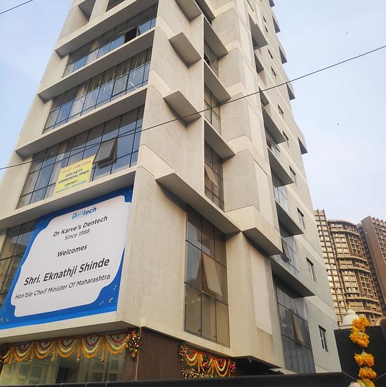 facade images of Maxxvalue Hotel, Chitranjan Tower, Powai, showcasing the concrete building from a lower angle2