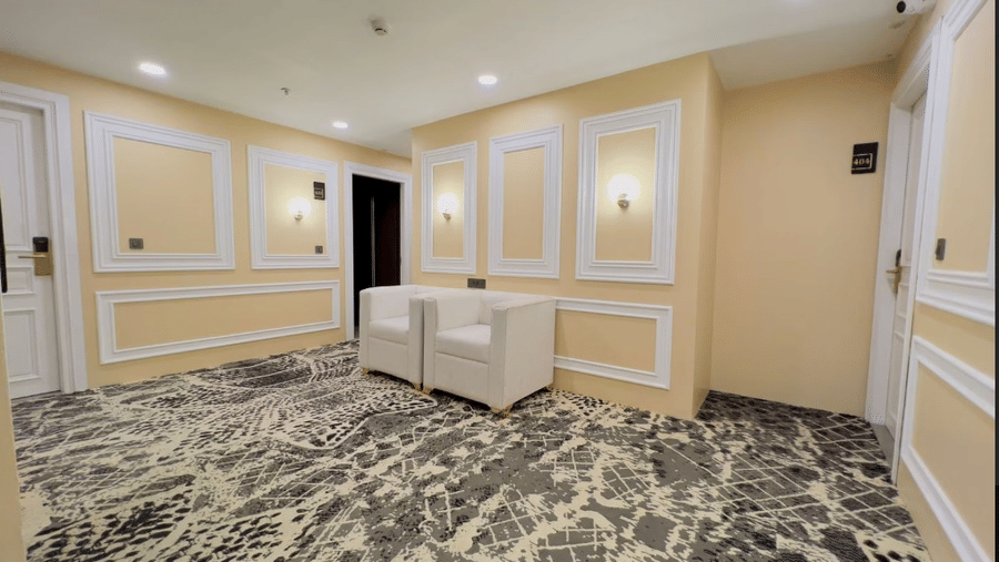 Spacious hall with modern decor, patterned carpet, and neutral-coloured walls at Claret Inn, Dalhousie.