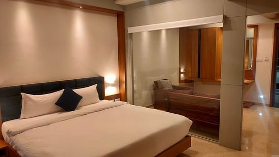 A picture of a bedroom showcasing a large bed and ample space for stretching out comfortably