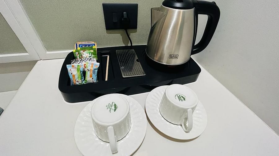 An image showcasing a kettle, cups, plates and packets of tea and coffee - Five Elements Hotels Goldleaf, Haldwani