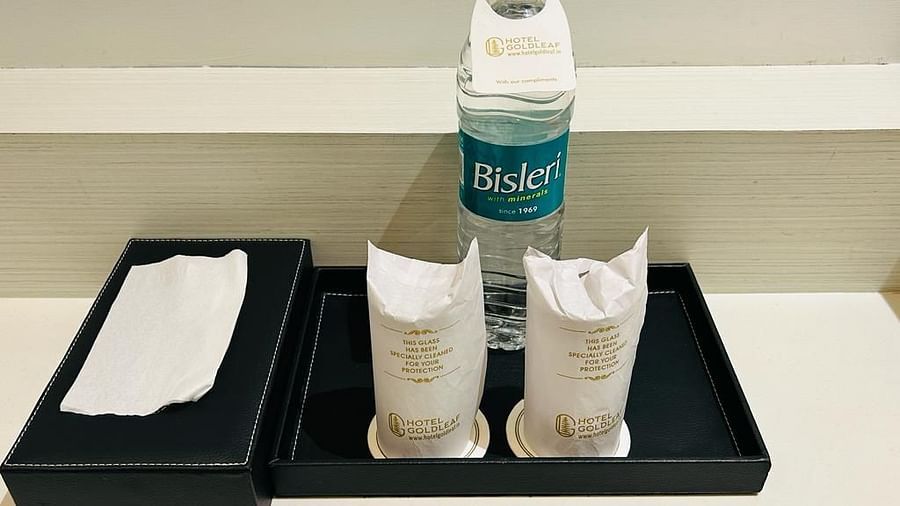  A tray with a mineral water bottle, glasses and tissues - Five Elements Hotels Goldleaf, Haldwani