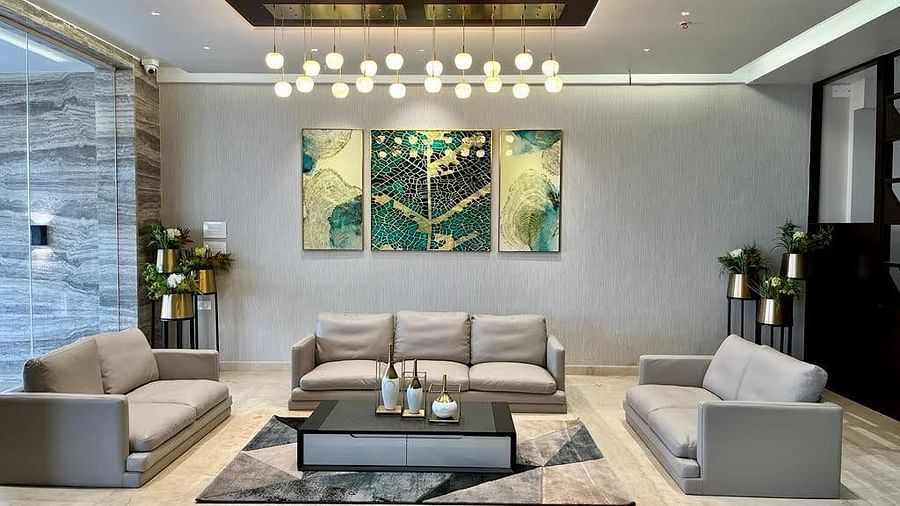 A front view of the lobby with three sofas and one coffee table in the center