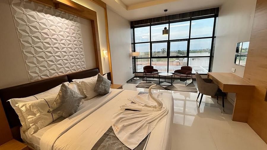 Room with a comfortable double bed and a huge glass window
