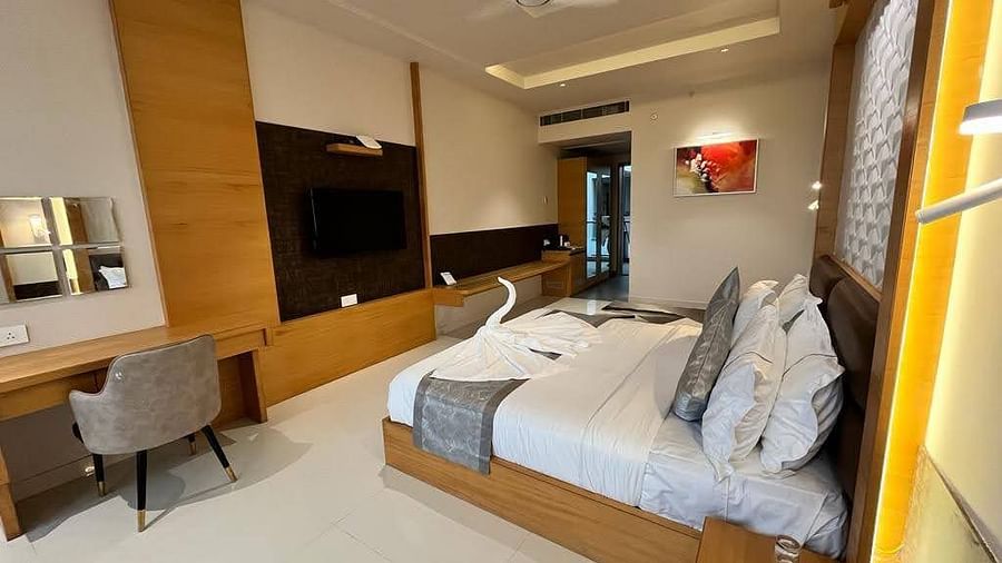A spacious room with a bed and bedding
