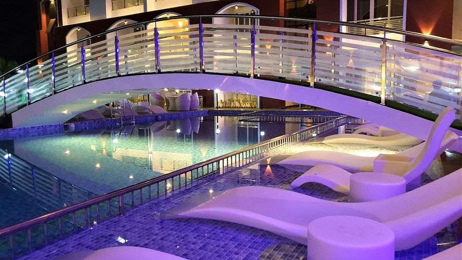 night view of the loungers with a bridge over the swimming pool - VITS shanti solitaire, North Goa