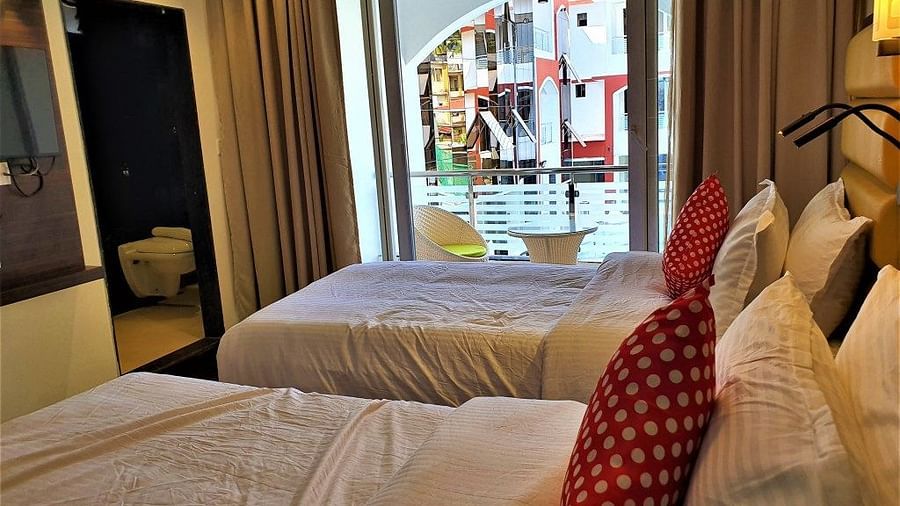 a twin bed inside a room at VITS shanti solitaire, North Goa