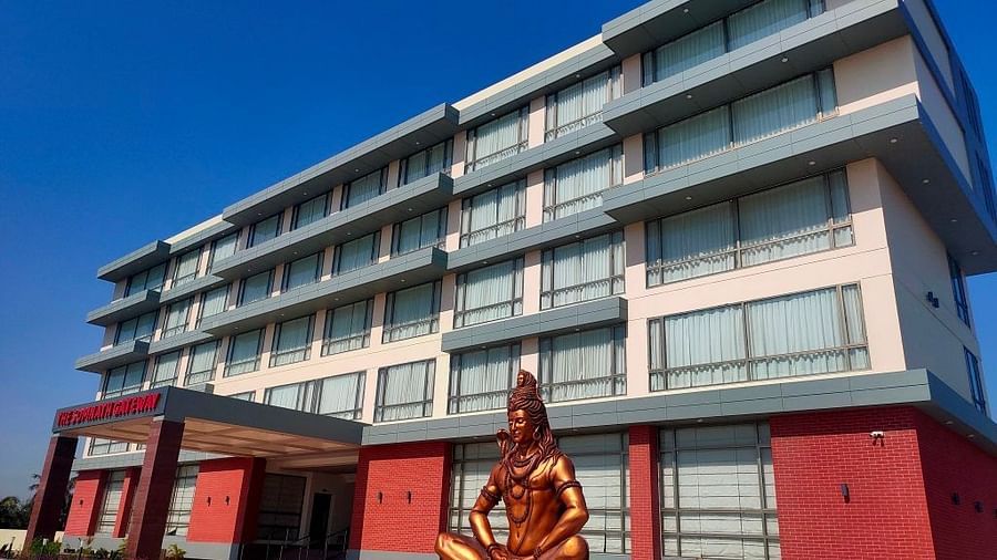 An image of the enormous hotel with lord shiva statue at the front 