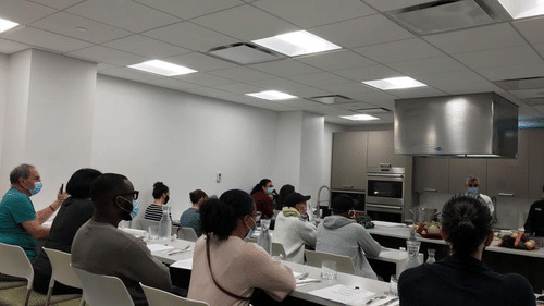 A group of people in a kitchen, seated at YO1 Longevity & Health Resort