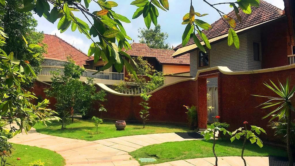 facade image of the luxury jucuzzi villas nestled amidst lush greenery at hoysala village resort in hassan