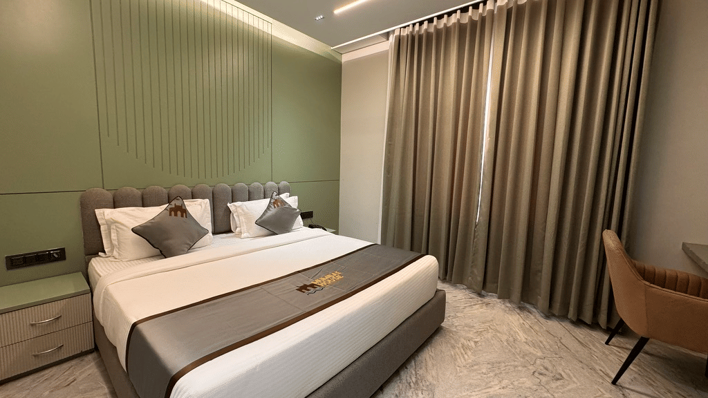 Modern room with king bed with soft lighting and contemporary decor at a business hotel in Pithampur