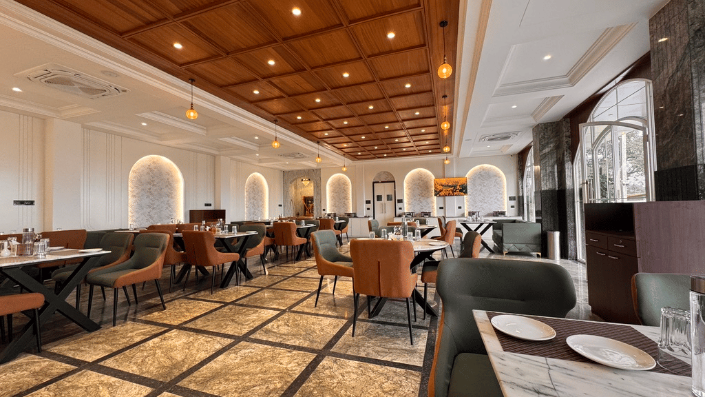 Spacious restaurant with elegant seating and warm lighting at a hotel in Pithampur