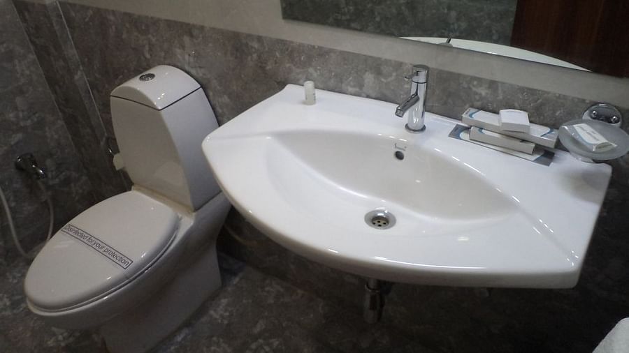 Modern bathroom with a toilet and sink with marble finish