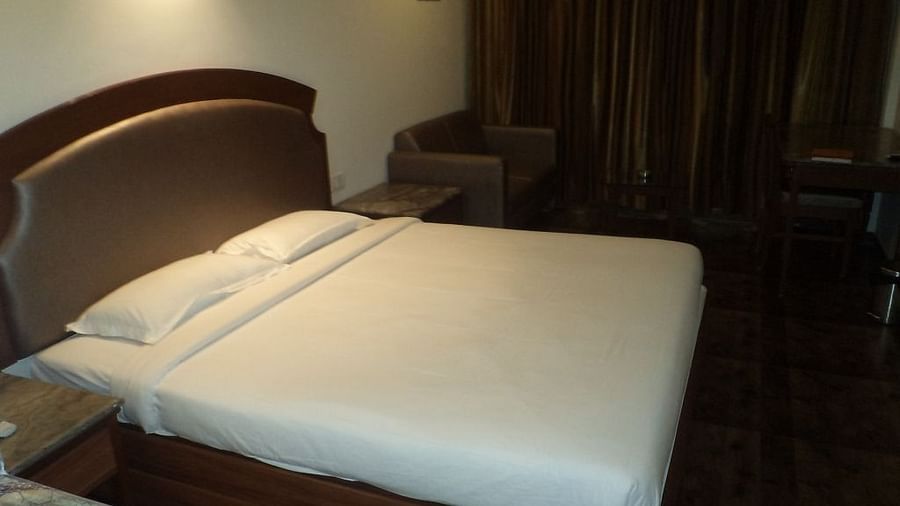 Cozy hotel room with a double bed and dark curtains