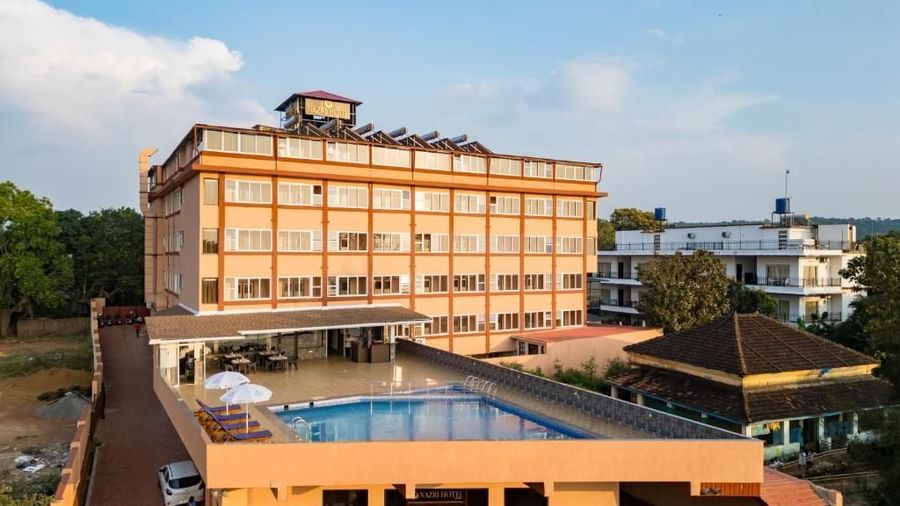 PropeAn elevated view of the hotel building overlooking the pool and lush surroundings at Nazri The Verda, Arambol.rt image 2