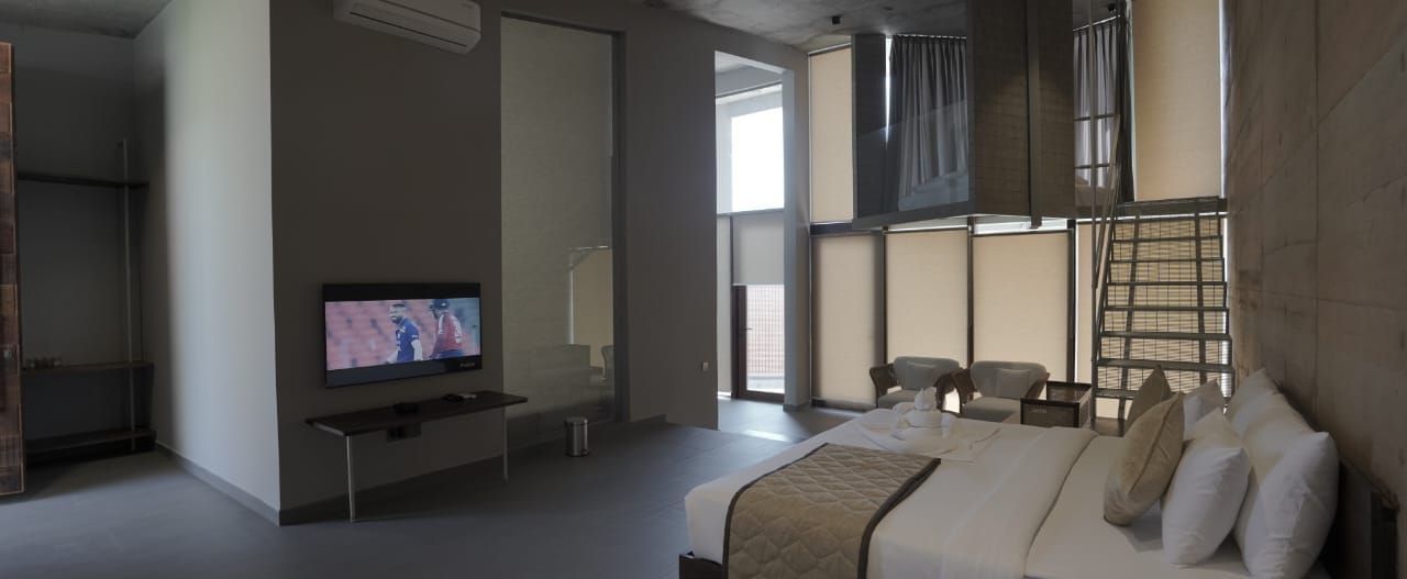 A hotel room with a bunk bed and a TV.