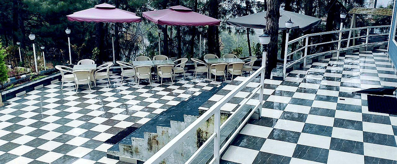 Open restaurant at DLS Nature Trinket Resort with chairs and tables.