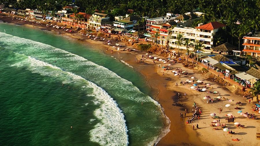 Overview of kovalam beach with buildings and people in view