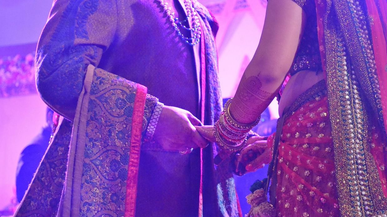A bride and a groom holding hands at one of the best wedding halls in Shimla