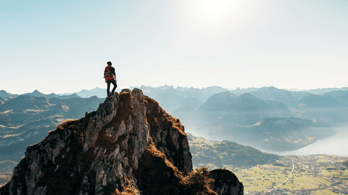 Trekker standing at Naini Peak