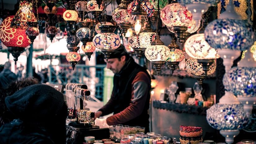 Man selling lamps and crockery at a night market
