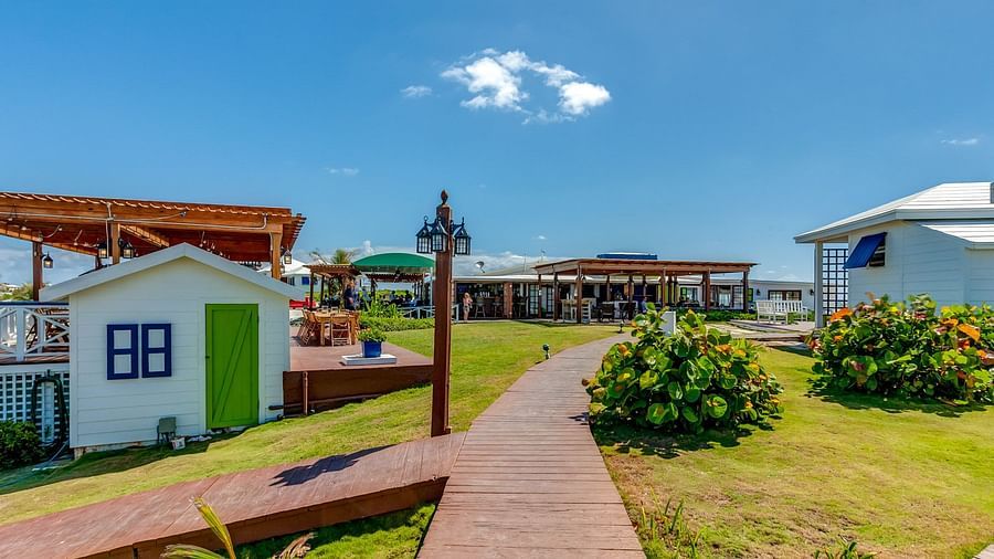 Paved walkway between buildings and greenery | Abaco Inn
