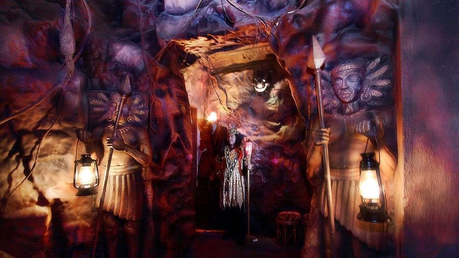 Mystical cave-themed restaurant interior with dramatic lighting and rugged stone walls, creating an enchanting dining experience at The President Hotel Jayanagar, Bangalore