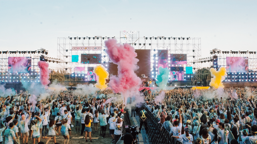 an image of a concert with people playing with colours
