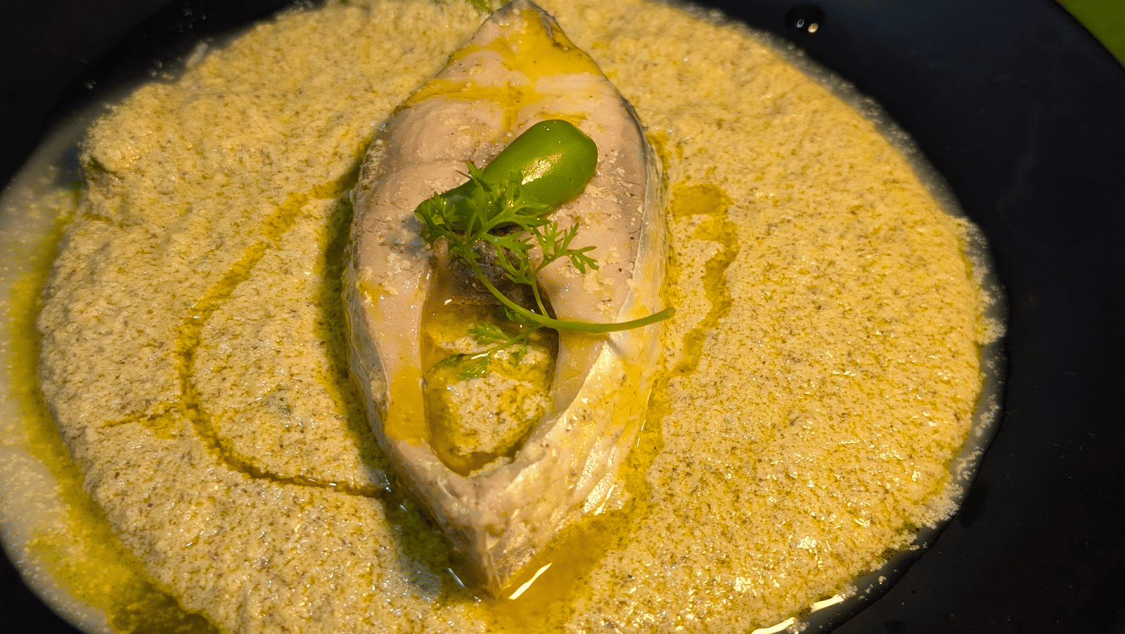 Close up of the traditional mustard hilsha fish curry at Dip Holidays.