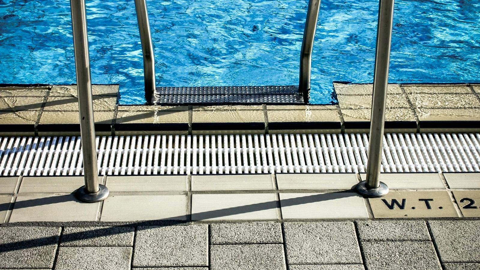 Metal railings near the swimming pool on a sunny day.
